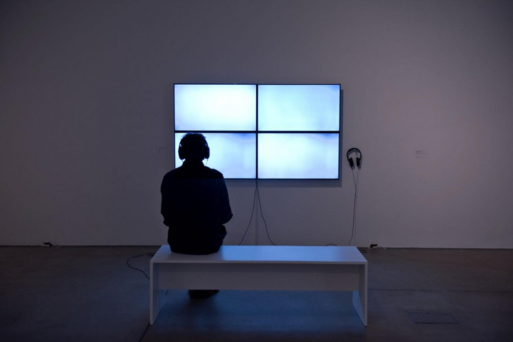 A visitor enjoys the video by Romily Alice Walden at Baltic29.