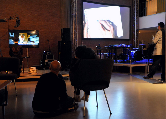 People in front of video installation and stage