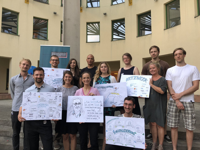 Gruppenfoto im Freien mit 13 Personen vom Weizenbaum-Institut mit den Forschungsgruppen „Datenbasierte Geschäftsmodellinnovation“ und „Vertrauen in verteilten Umgebungen“