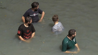 Men in murky water